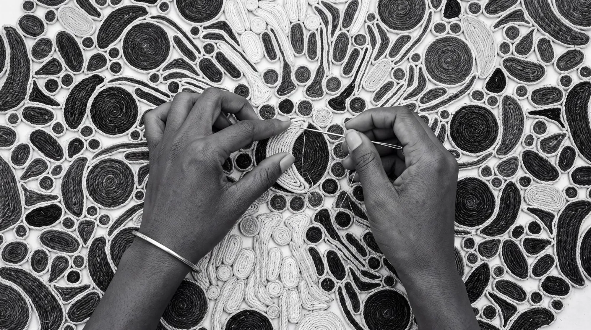 Three artisans at work in the workshop, black-and-white photograph